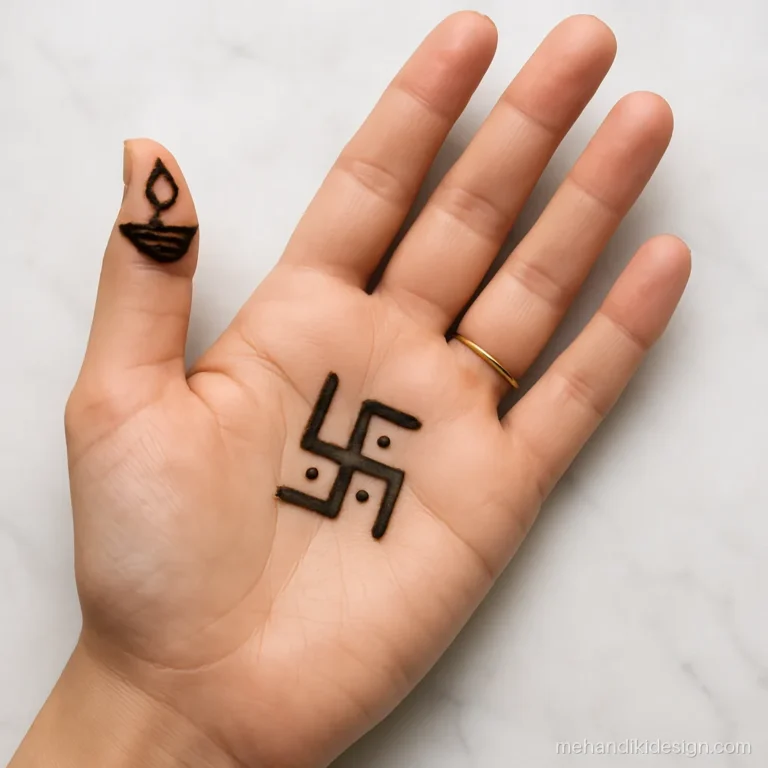 Simple Diwali mehandi with a small swastik on the palm and diya on the thumb