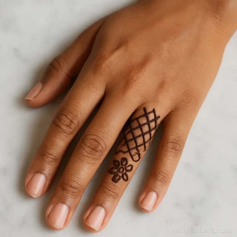 Simple finger mehandi with criss cross lines and a flower at the base