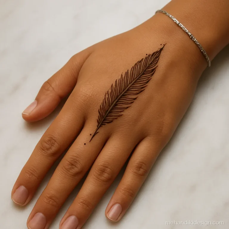 Tattoo style mehandi of a single feather along the side of the hand